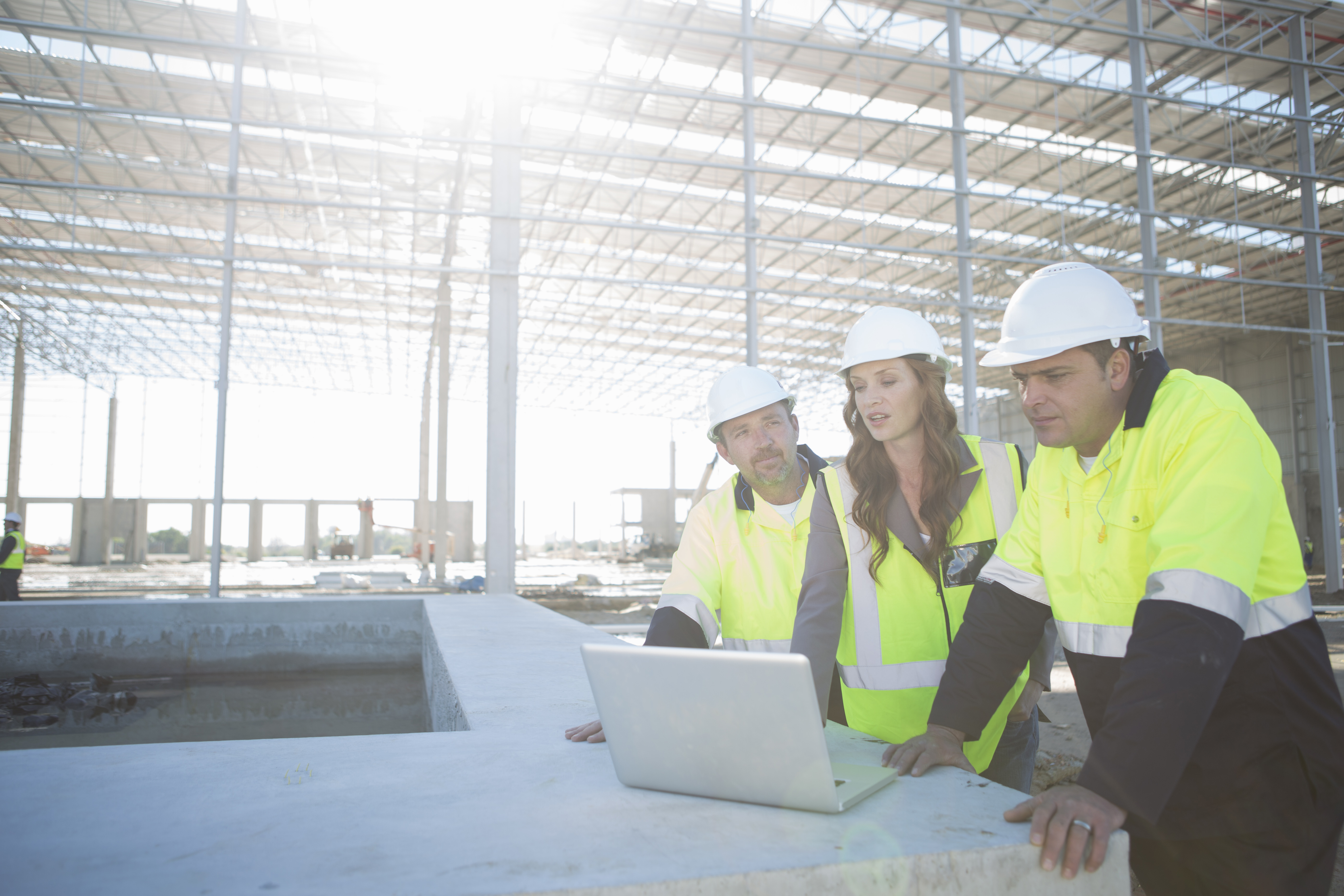 Site managers and architect reviewing plans